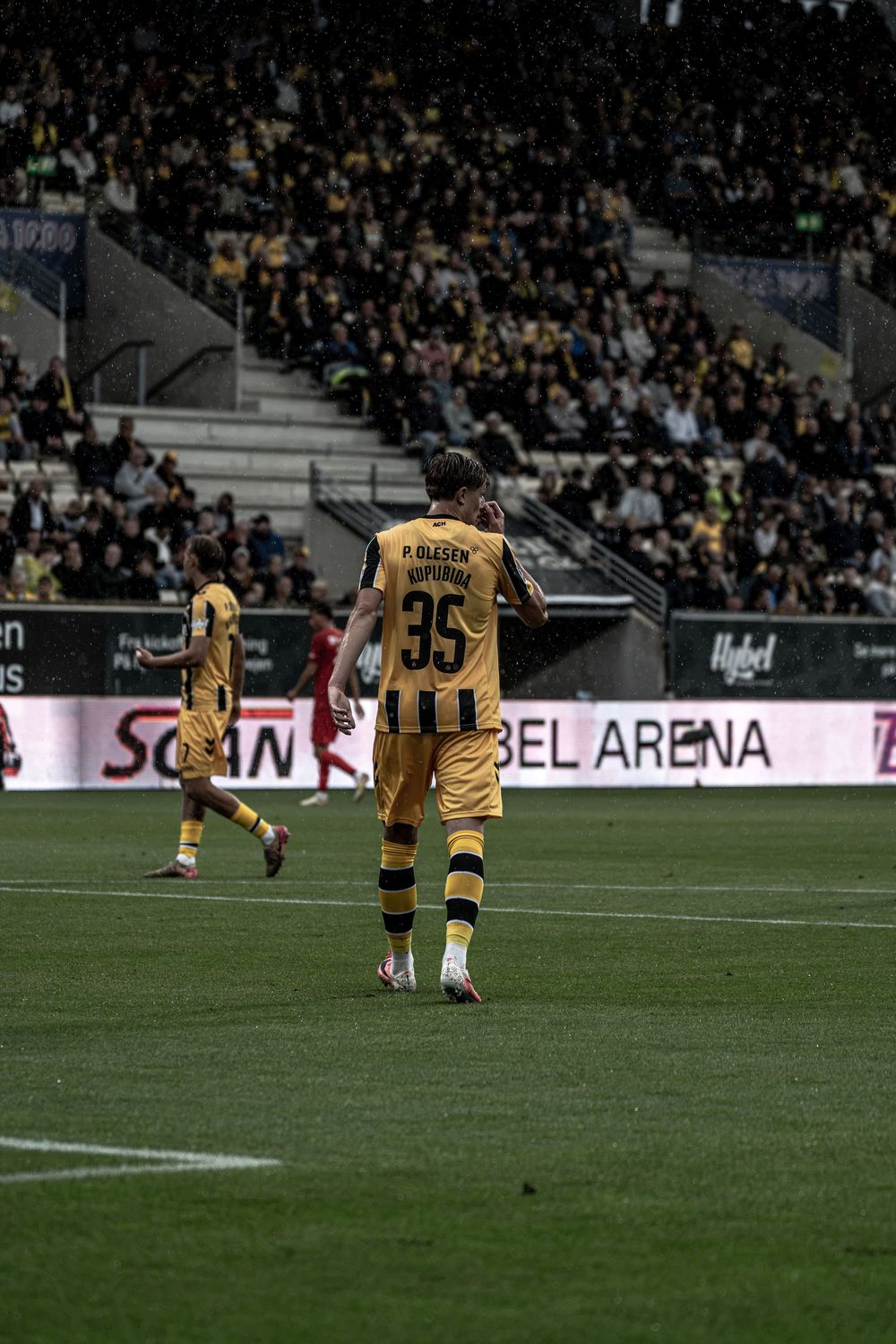 Soccer player wearing number 35 jersey walks on field at Hubel Arena during a professional match.