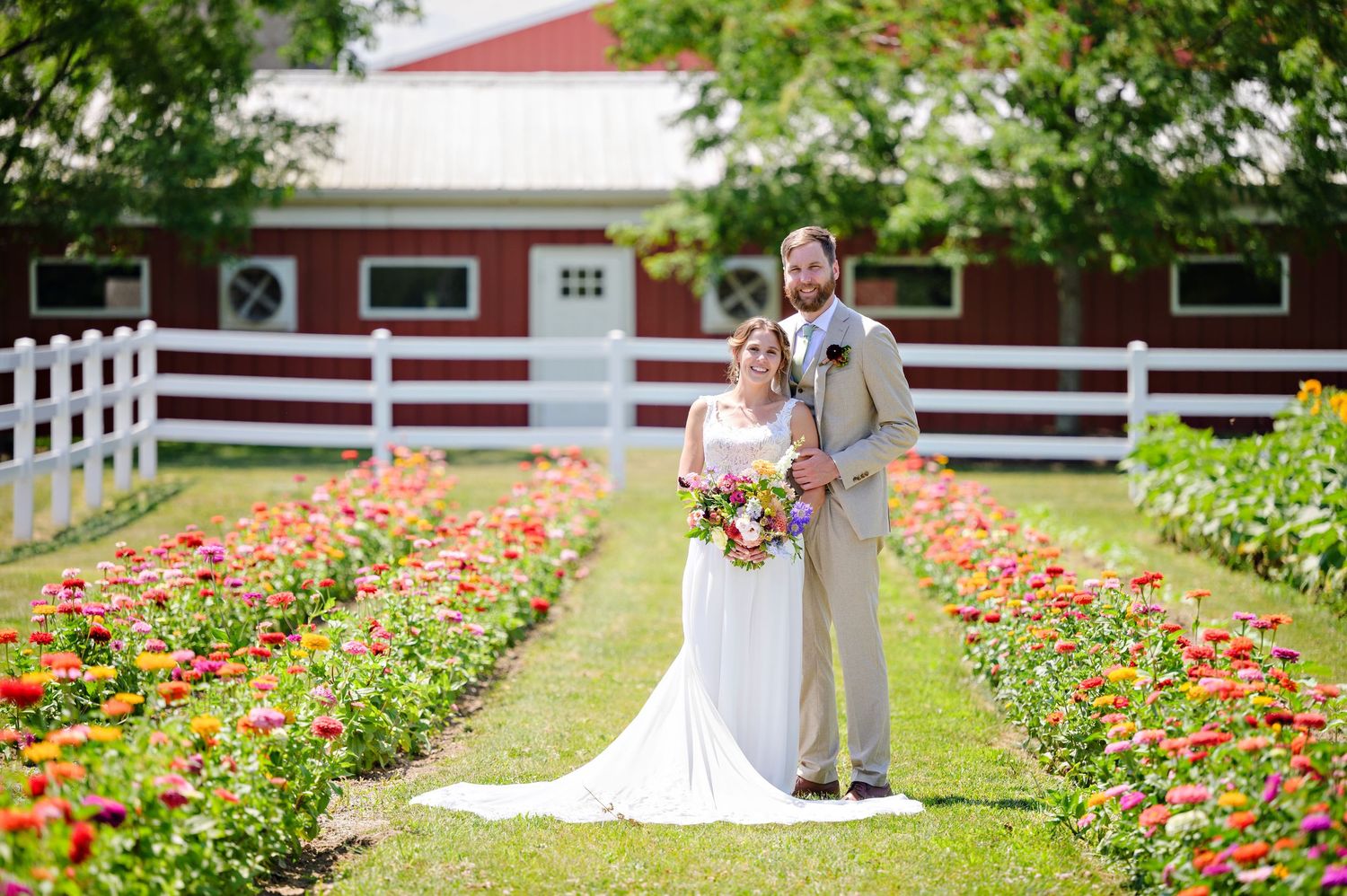 Bride and groom posing in the flower field after their wedding ceremony at Kilkerrin in Wakeman Ohio on a hot July day in the summer