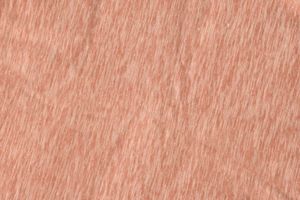 Light peach pink textured fabric background with subtle diagonal grain pattern for design projects.