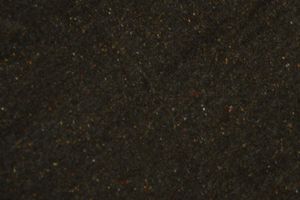 Dark green granite surface with scattered red and gold mineral flecks, ideal for countertops or flooring.
