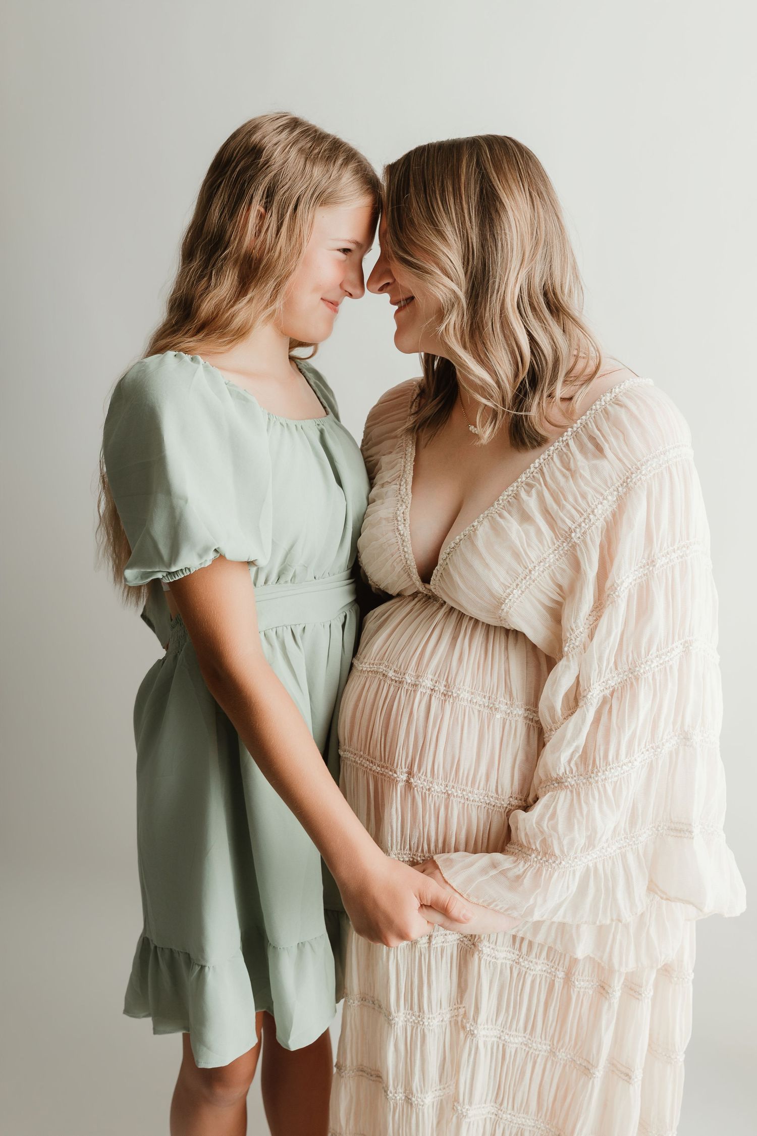 Mother and daughter embracing during a maternity photography session in Tyler Texas