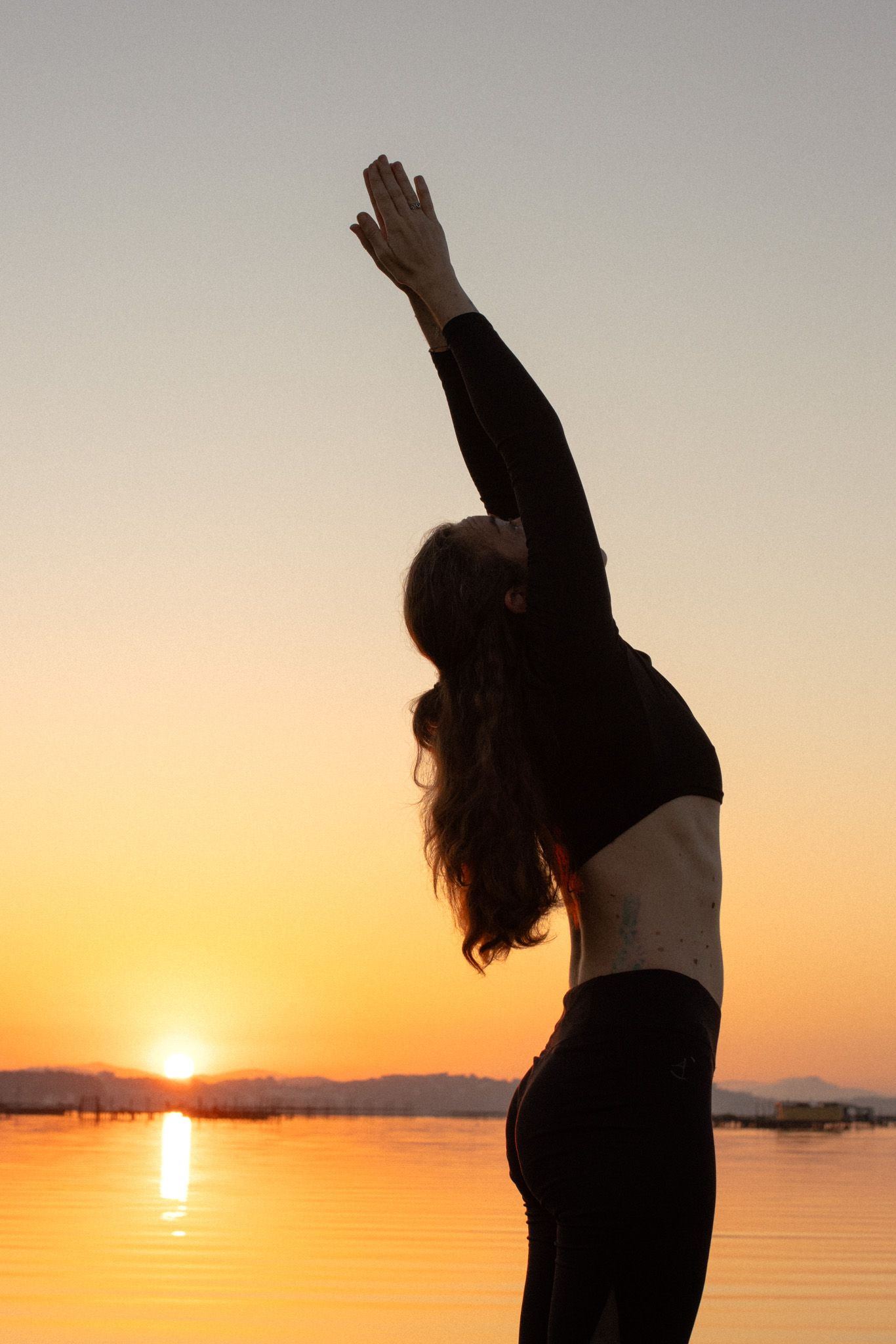 Woman practicing yoga outdoors in natural light