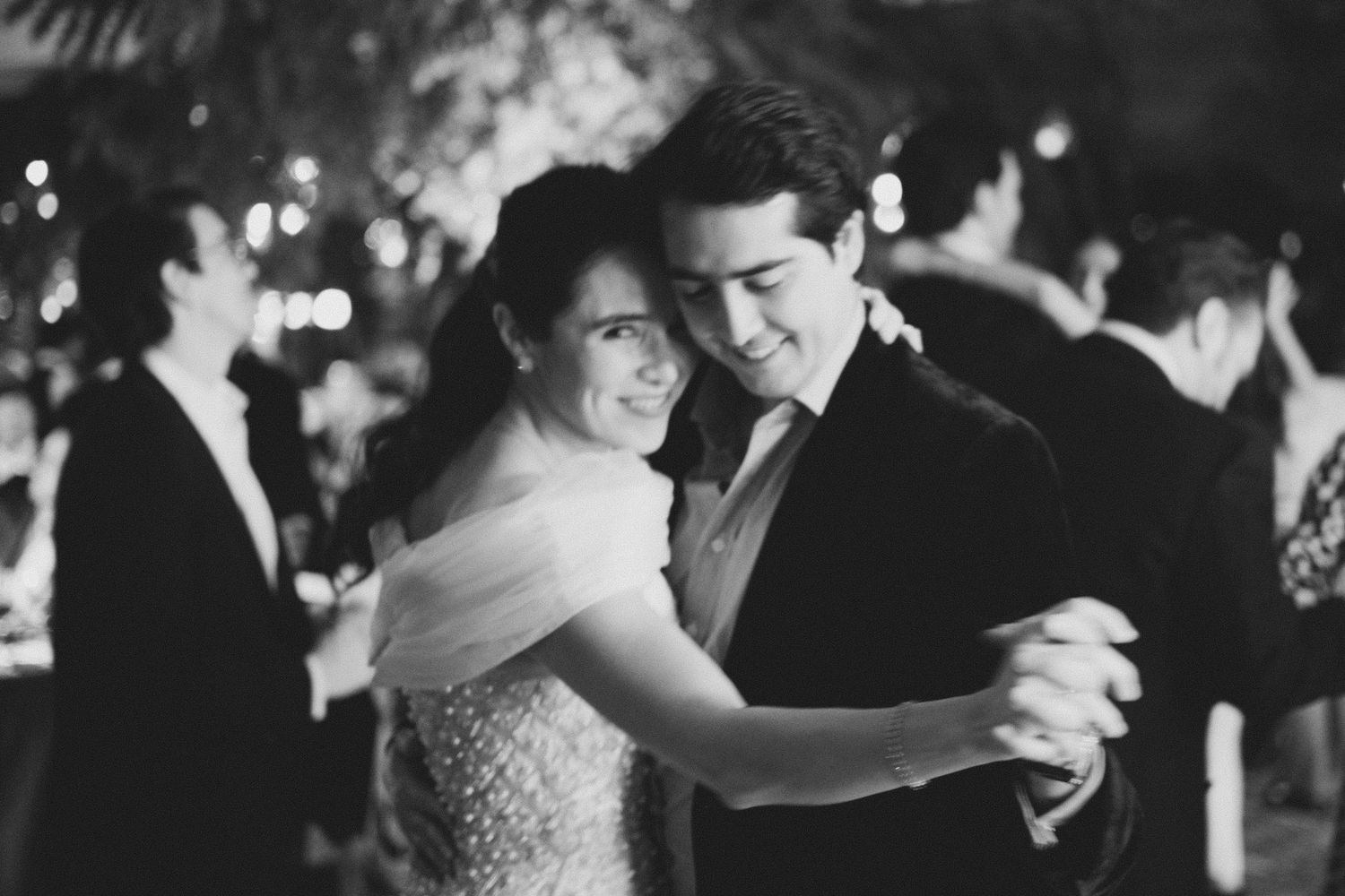 Couples dance together during an elegant black and white wedding reception celebration.