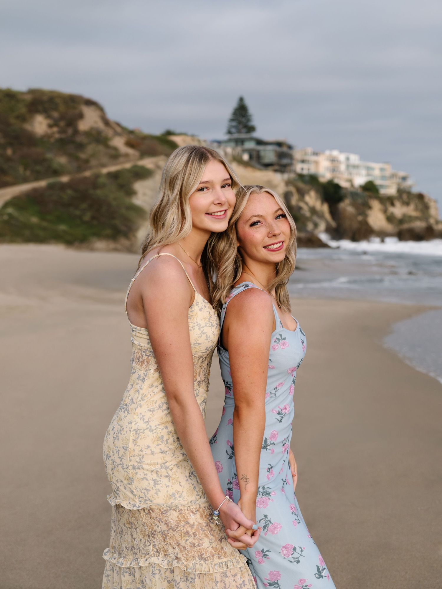 Two family members standing together on the beach during an Orange County extended family photo session.