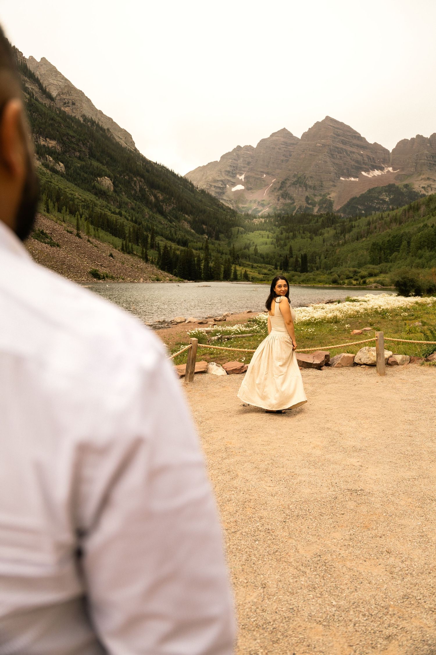 Couple shares a tender moment at Maroon Bells, Colorado, with stunning mountain backdrop during their outdoor wedding.