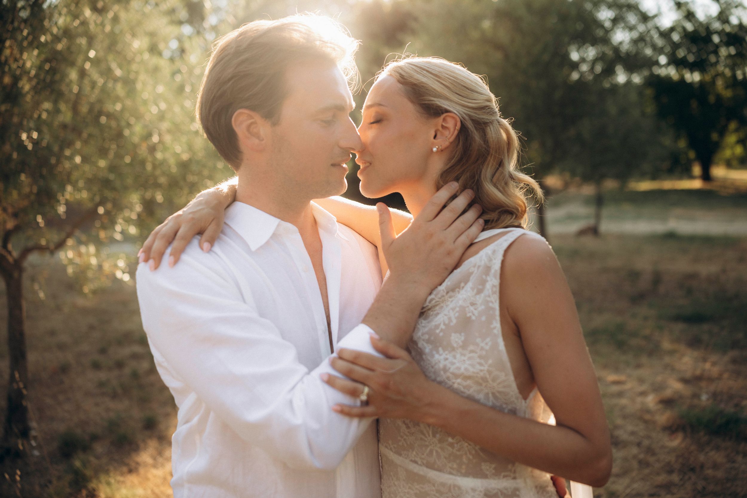 A romantic dance silhouette under stone archways with warm lighting.