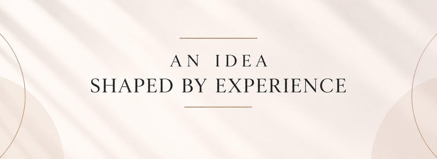 Elegant banner with text An Idea Shaped By Experience beside a vintage camera and framed photo on a marble surface.