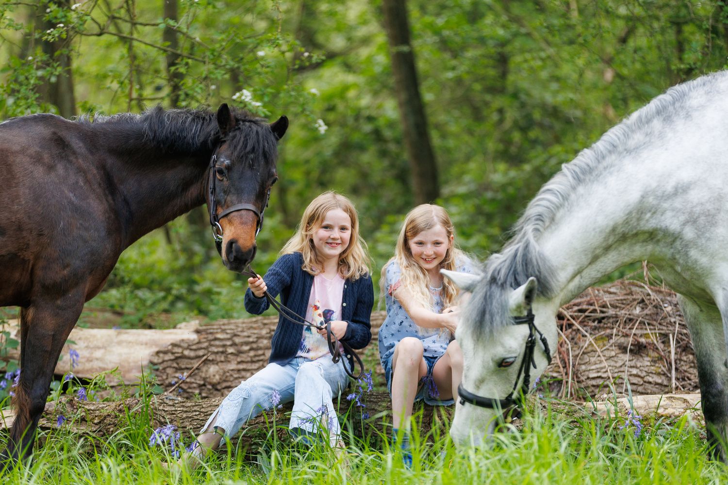 A horse and its rider enjoy an outdoor photoshoot session near rustic wooden fencing on a sunny day.