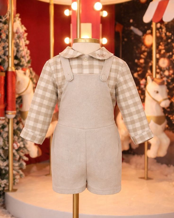 Baby outfit displayed on mannequin featuring beige gingham shirt and matching linen shortall overalls set.
