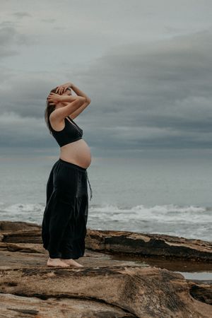 Pregnant woman looking out to the sea