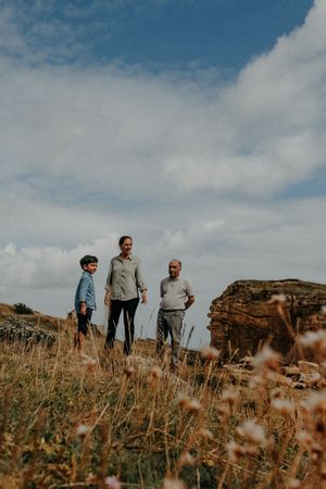 Family standing on hill at family photo session in Howick