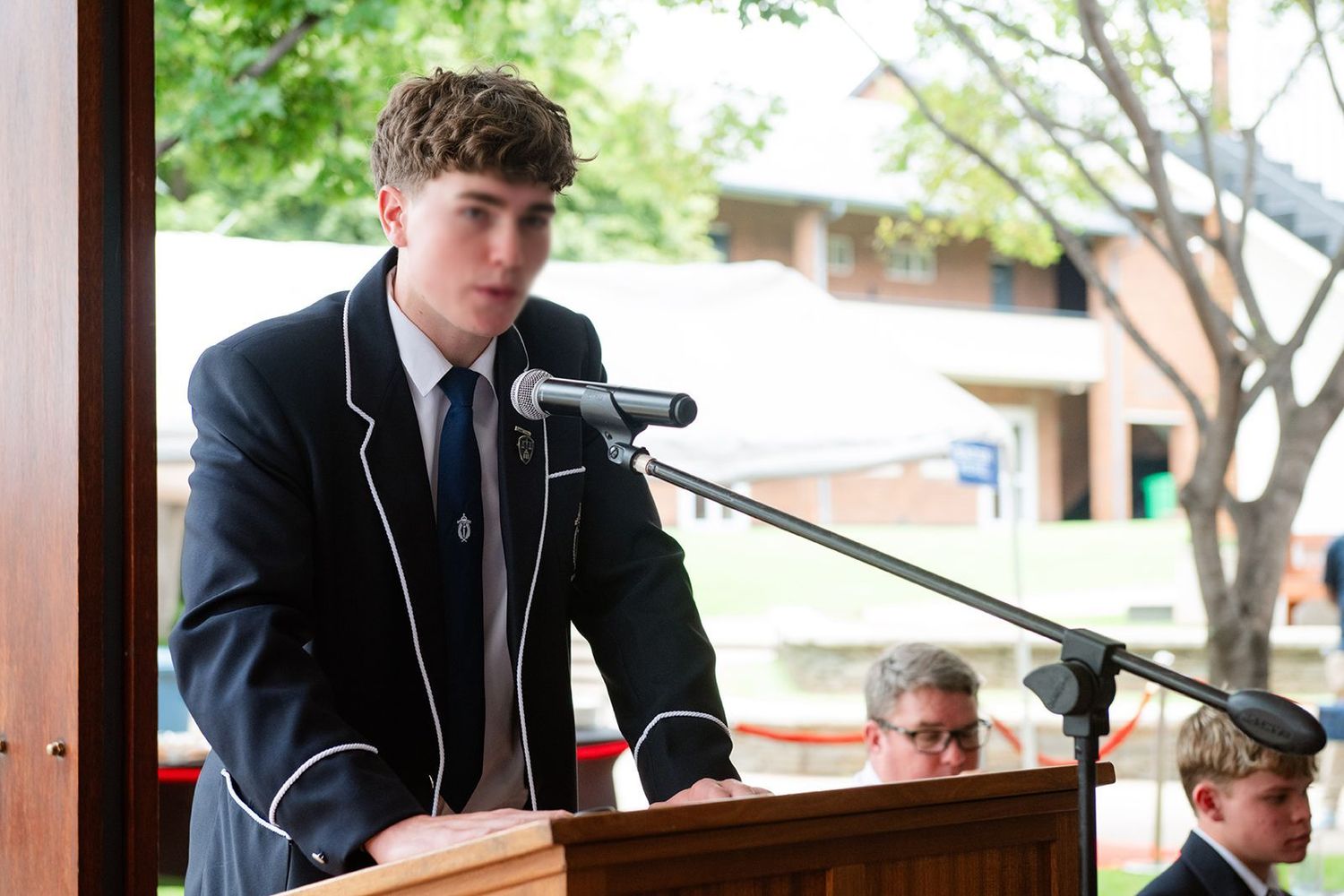 An image of a learner giving a speech at the first day of school.