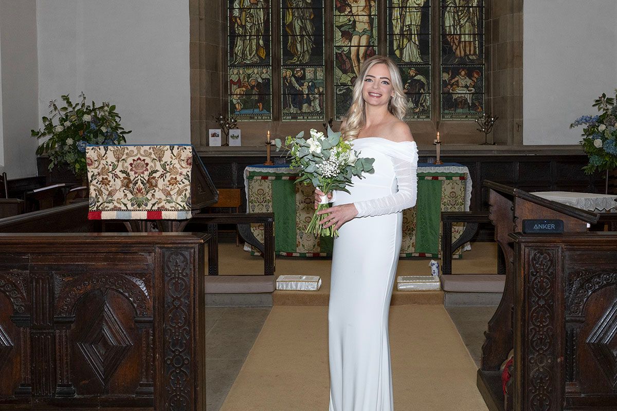 Anna stands at the alter at her Lake District elopement wedding