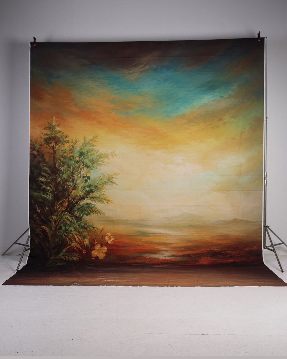 Colorful painted landscape photography backdrop with trees and sky on a stand.
