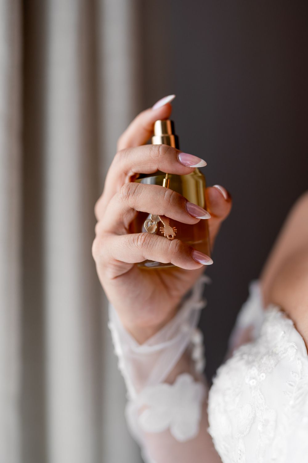 wedding photography of bride spraying perfum