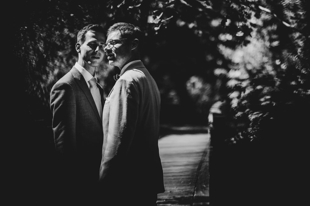 Artistieke LGBTQ+ huwelijksfoto in zwart wit van twee mannen, door huwelijksfotograaf Bart Boodts in België.