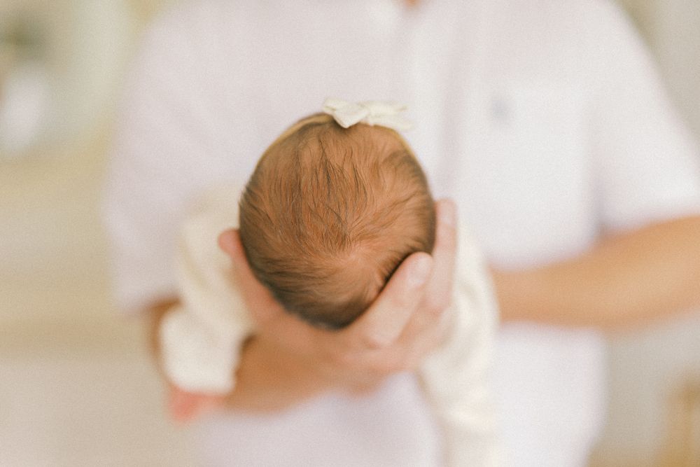 Newborn baby in dad's arms