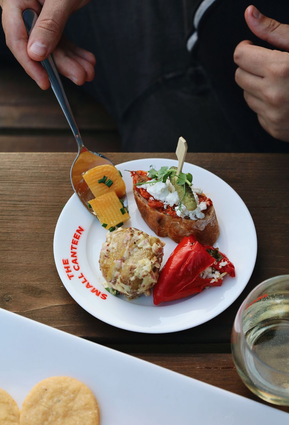 Elegant plated appetizers with colorful ingredients on white restaurant dishes.