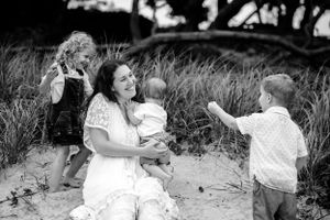 mum being tickled by children on the beach Coffs Harbour