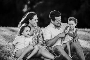happy family sitting on the grass