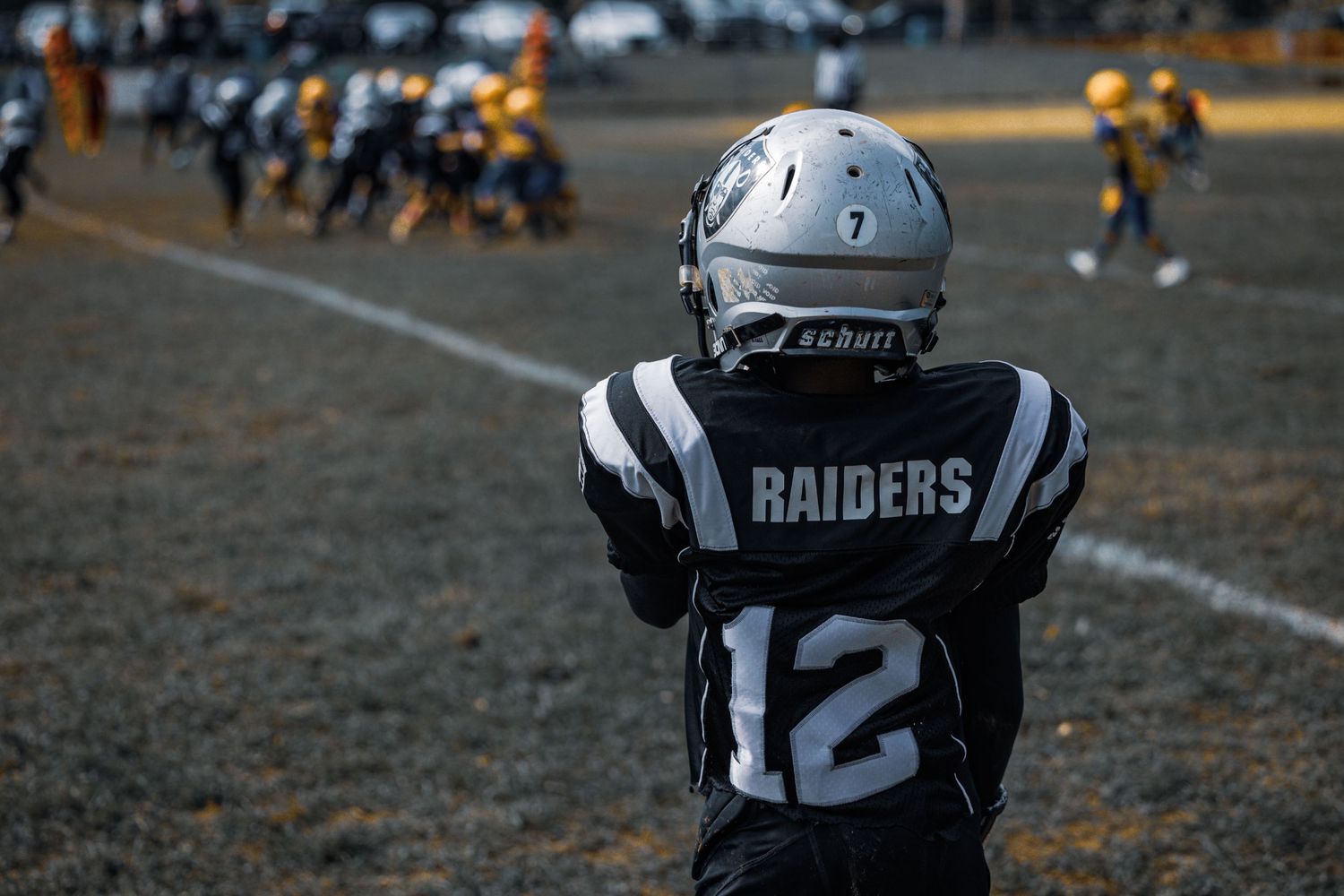 Raiders player number 12 watches the field from the defensive position.