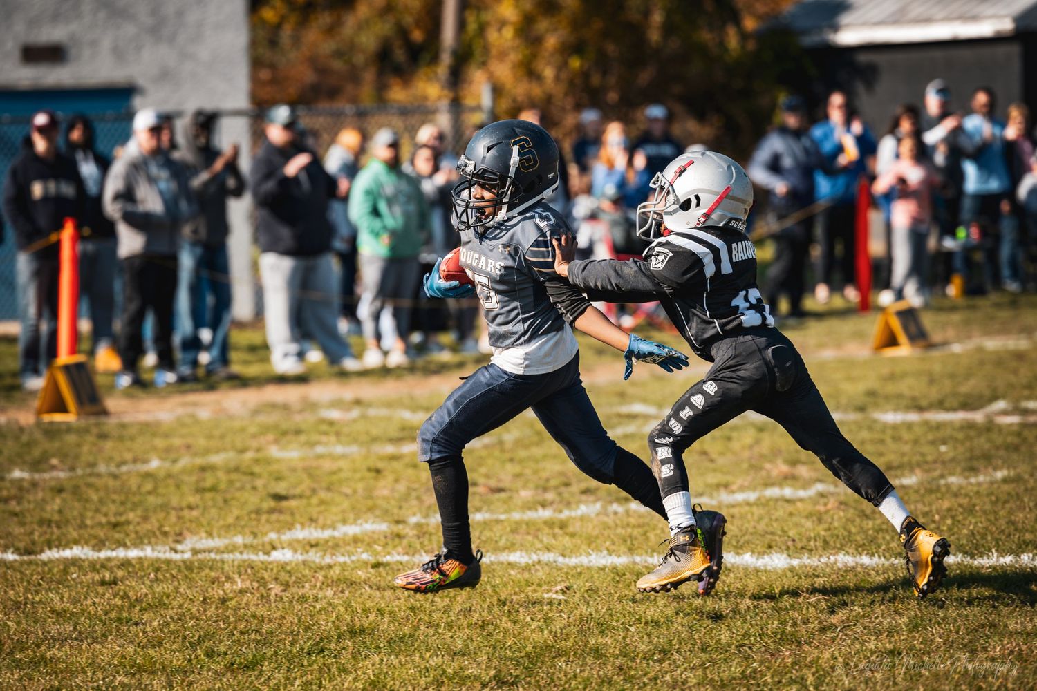 Athletic players in jerseys performing dynamic stretches on a sunny field.