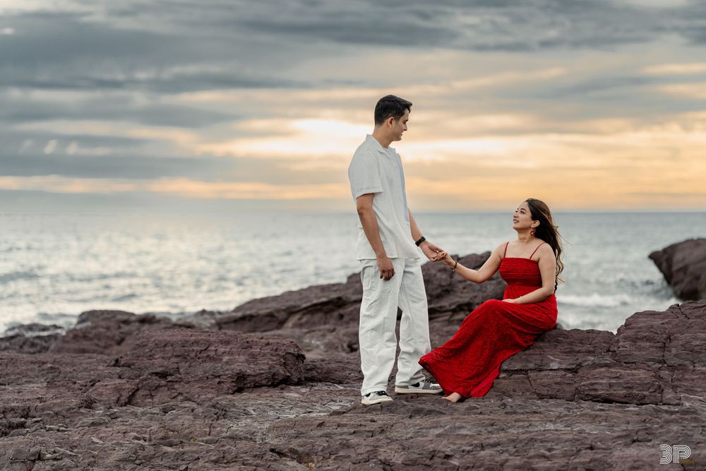 Engaged couple dressed in formal attire, posing elegantly in a sophisticated pre-wedding photoshoot setting.