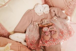 A series of romantic pink and white themed newborn baby photography images showing delicate lace details and soft textures.