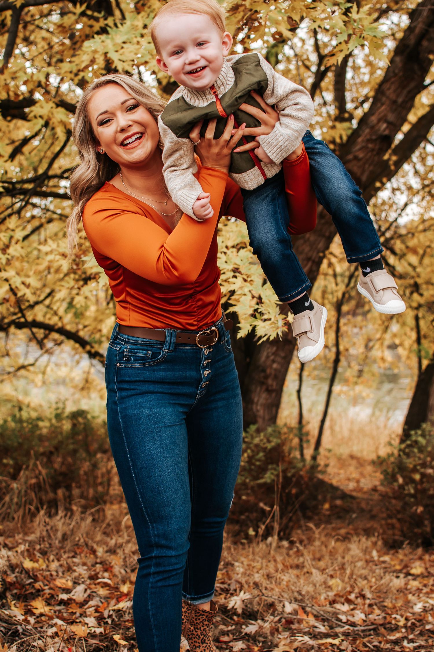 Candid autumn moment capturing laughter and play against golden leaves in Richland, Washington.