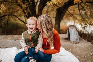 Sweet outdoor moment against autumn trees in a mommy and me session in Richland, Washington at Chamna Natural Preserve.