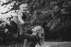 Black and white candid capturing joyful playtime moment between mother and son in Richland, Washington.