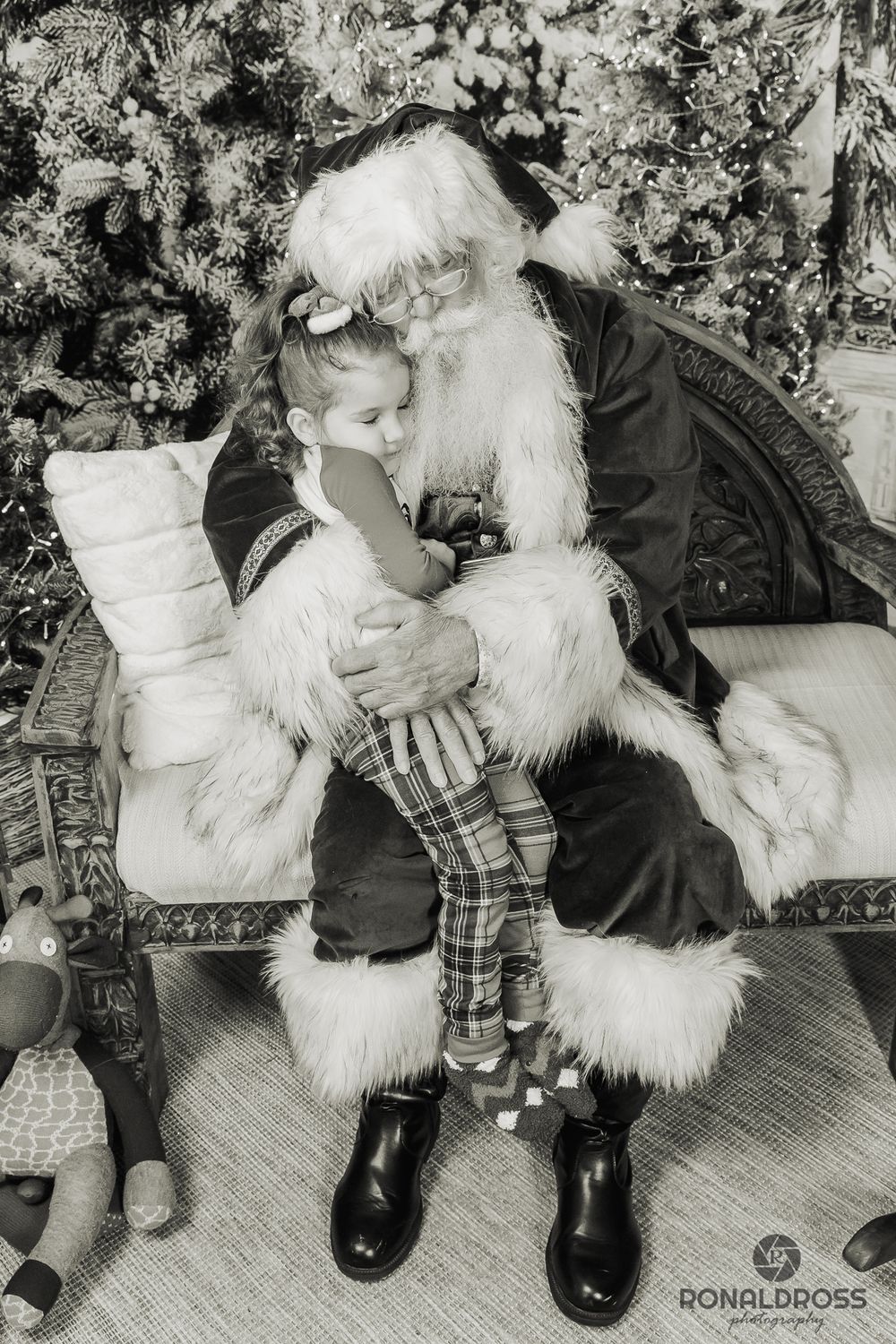 A sequence of black and white photos showing a child sitting on Santa's lap progressively getting more distressed. Santa Photos Webster