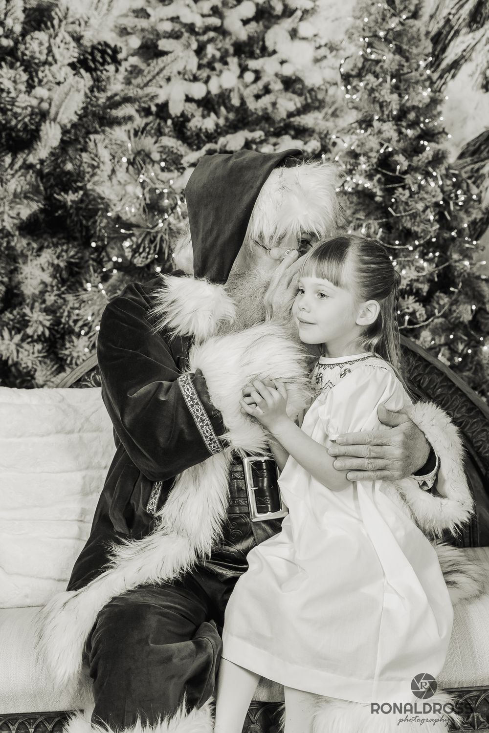 A series of black and white photos showing playful interaction between a child and a fluffy white dog in a garden setting. Webster, TX