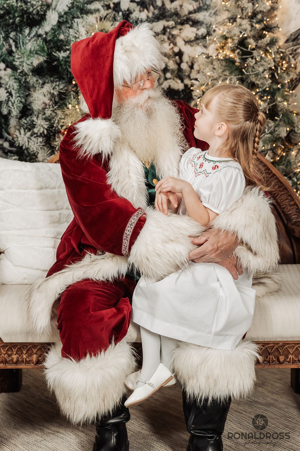 A series of magical holiday photos showing a heartwarming interaction with Santa Claus in front of a decorated Christmas tree. League City