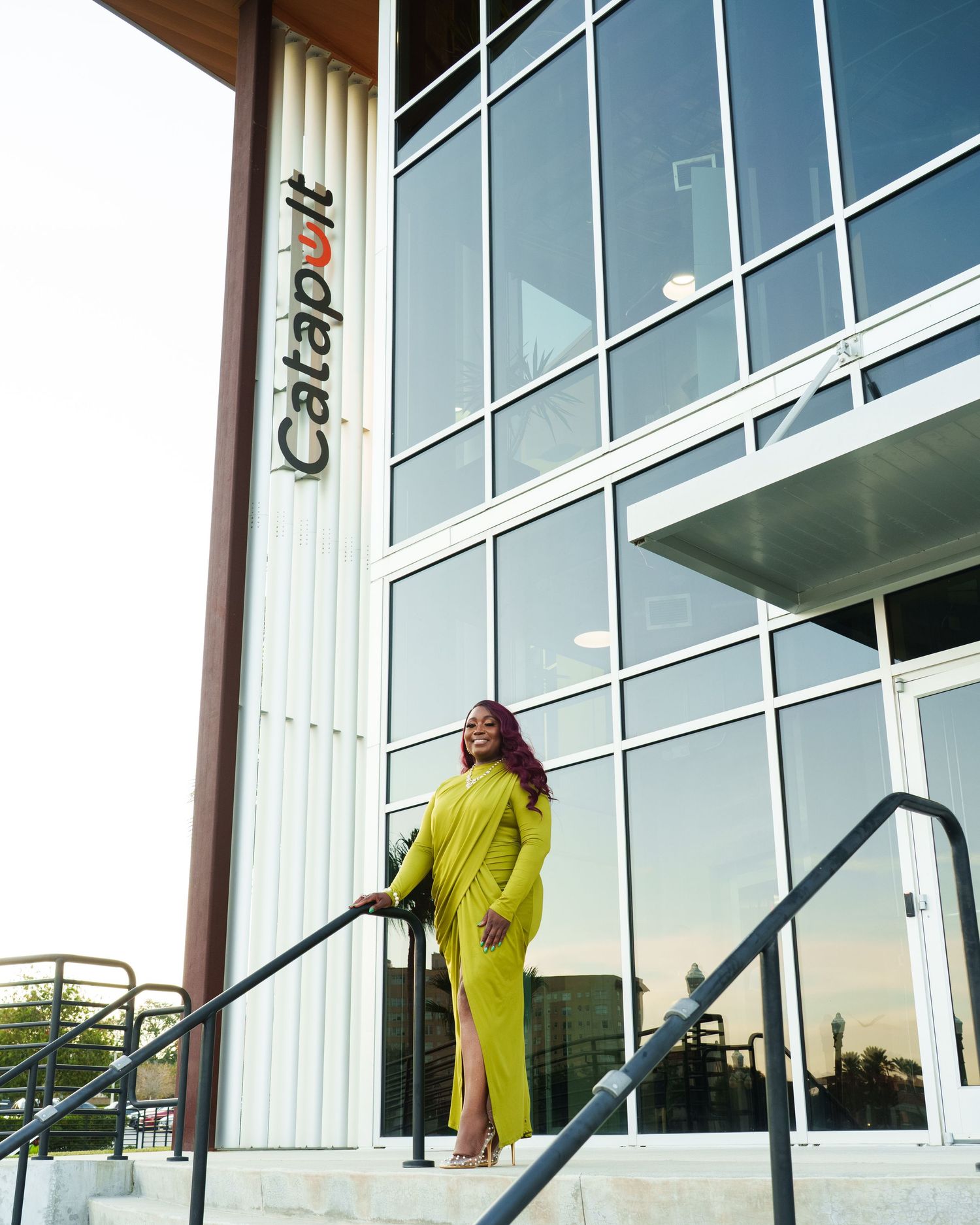 Woman in a green dress standing outside of Catapult in Lakeland Florida