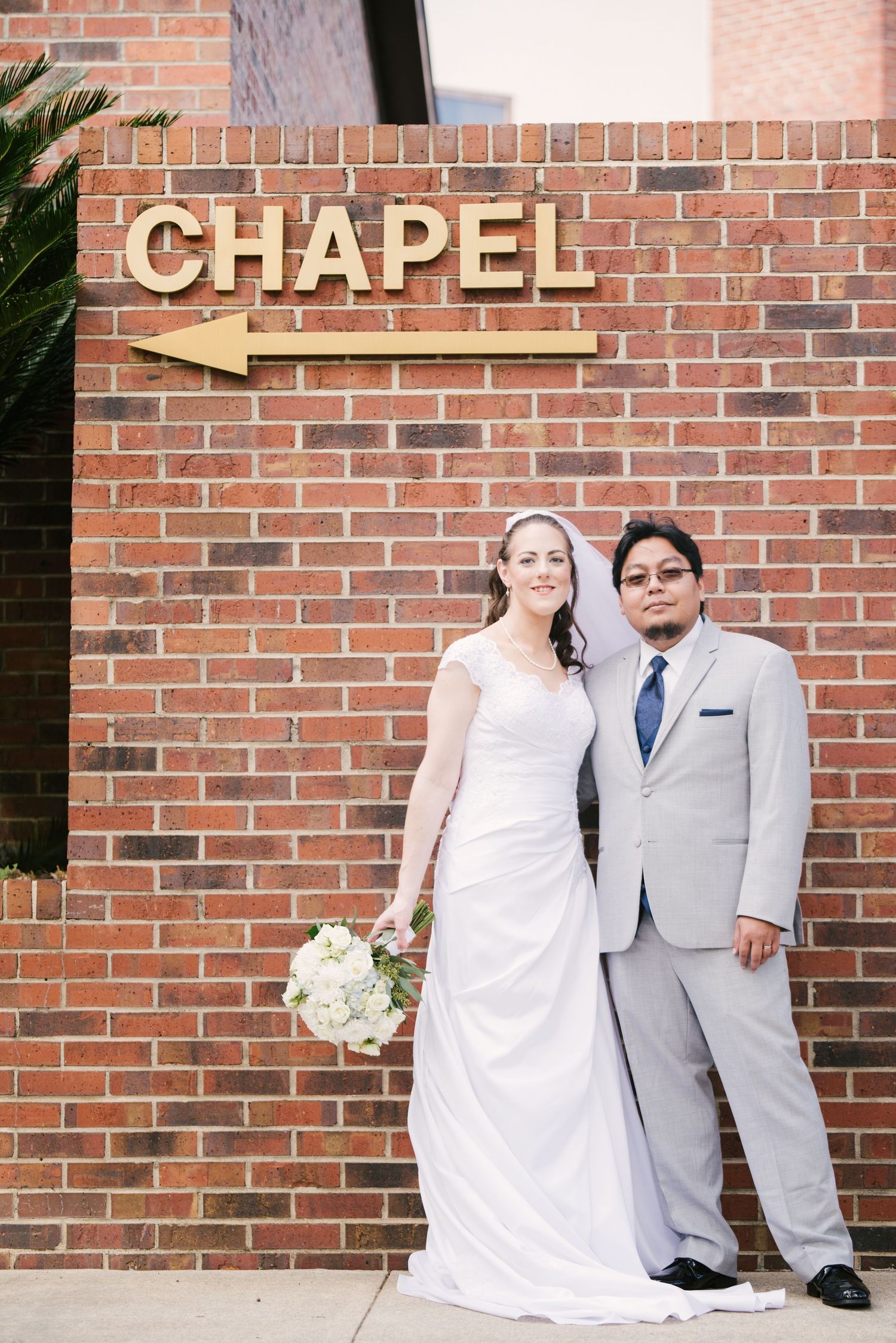A wedding couple poses against a brick wall with a chapel sign in a series of four connected photos.