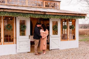 Panoramic view of a charming white building with wooden accents and large windows.