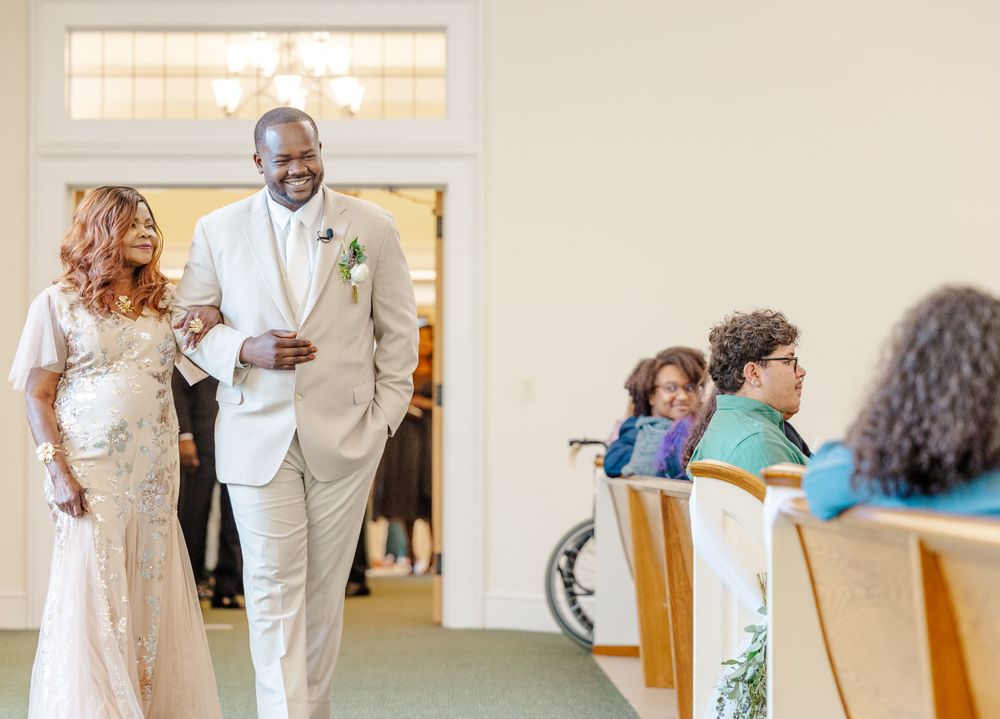 Couple walking down church aisle during wedding ceremony.
