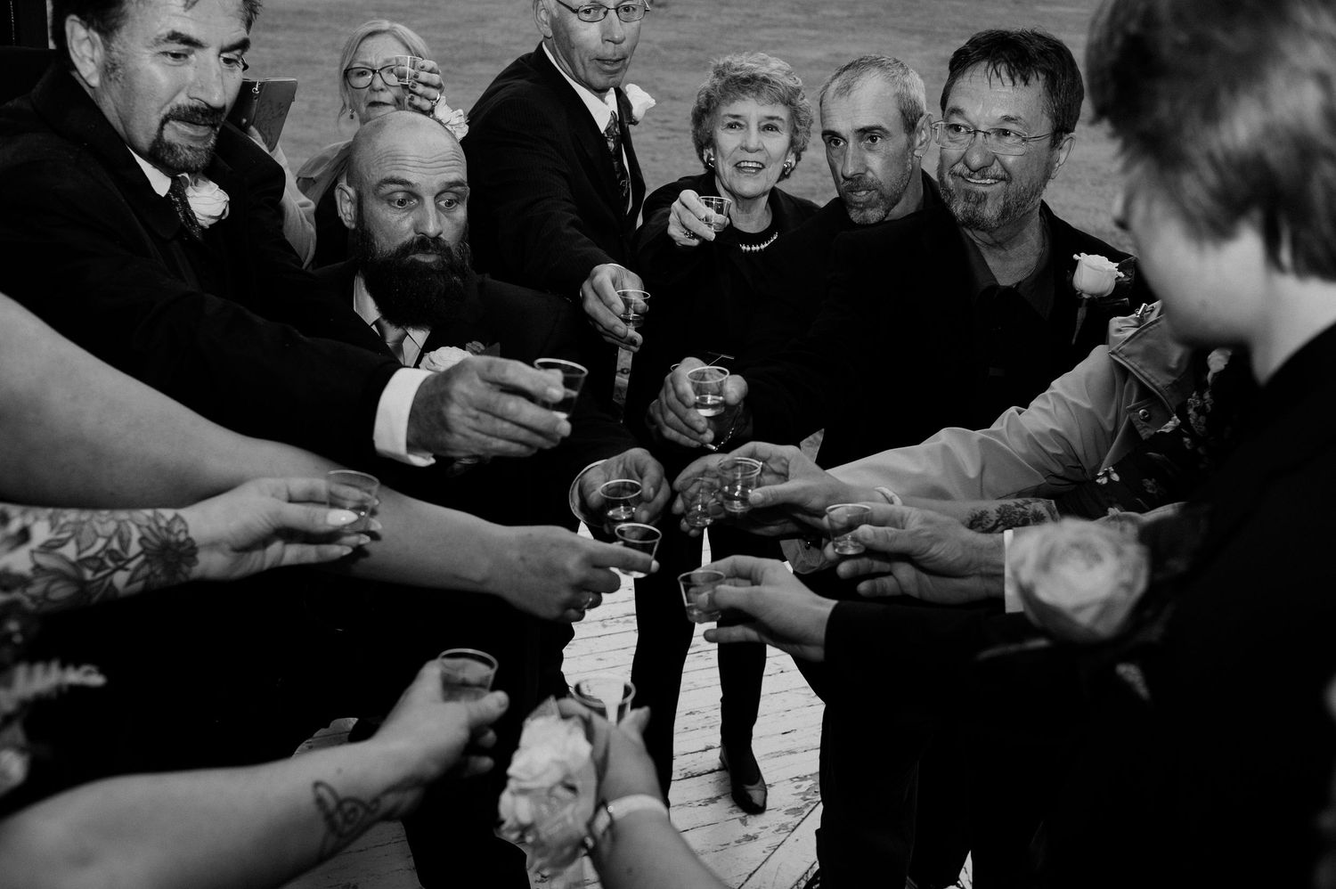 A group toasts with champagne glasses during a wedding celebration.