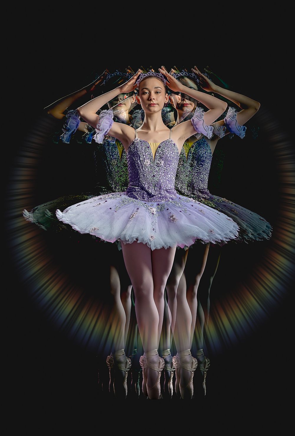 Ballet dancer in purple tutu with kaleidoscope mirror effect creating circular pattern.