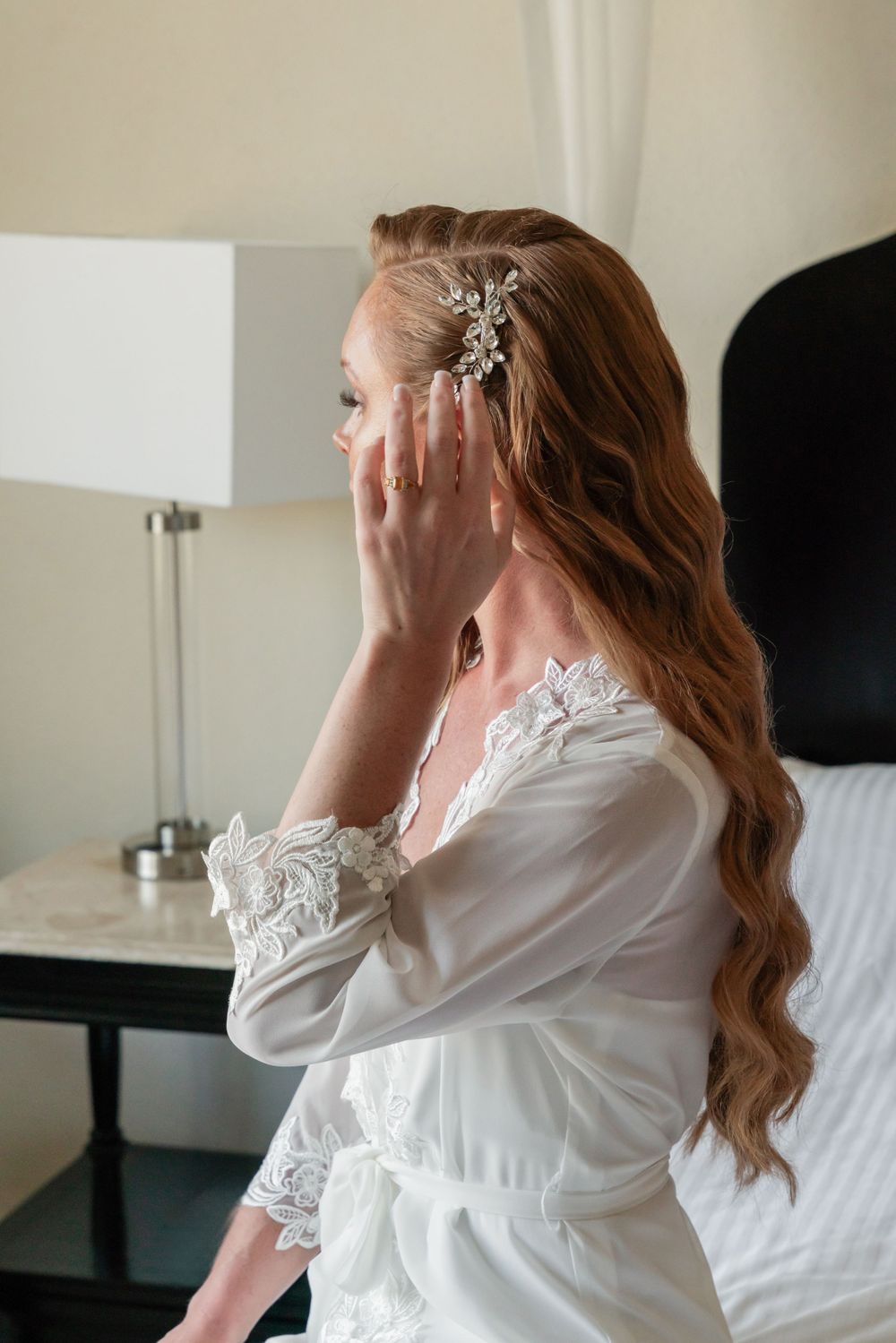 Close-up of elegant bridal hair accessories and lace robe details.