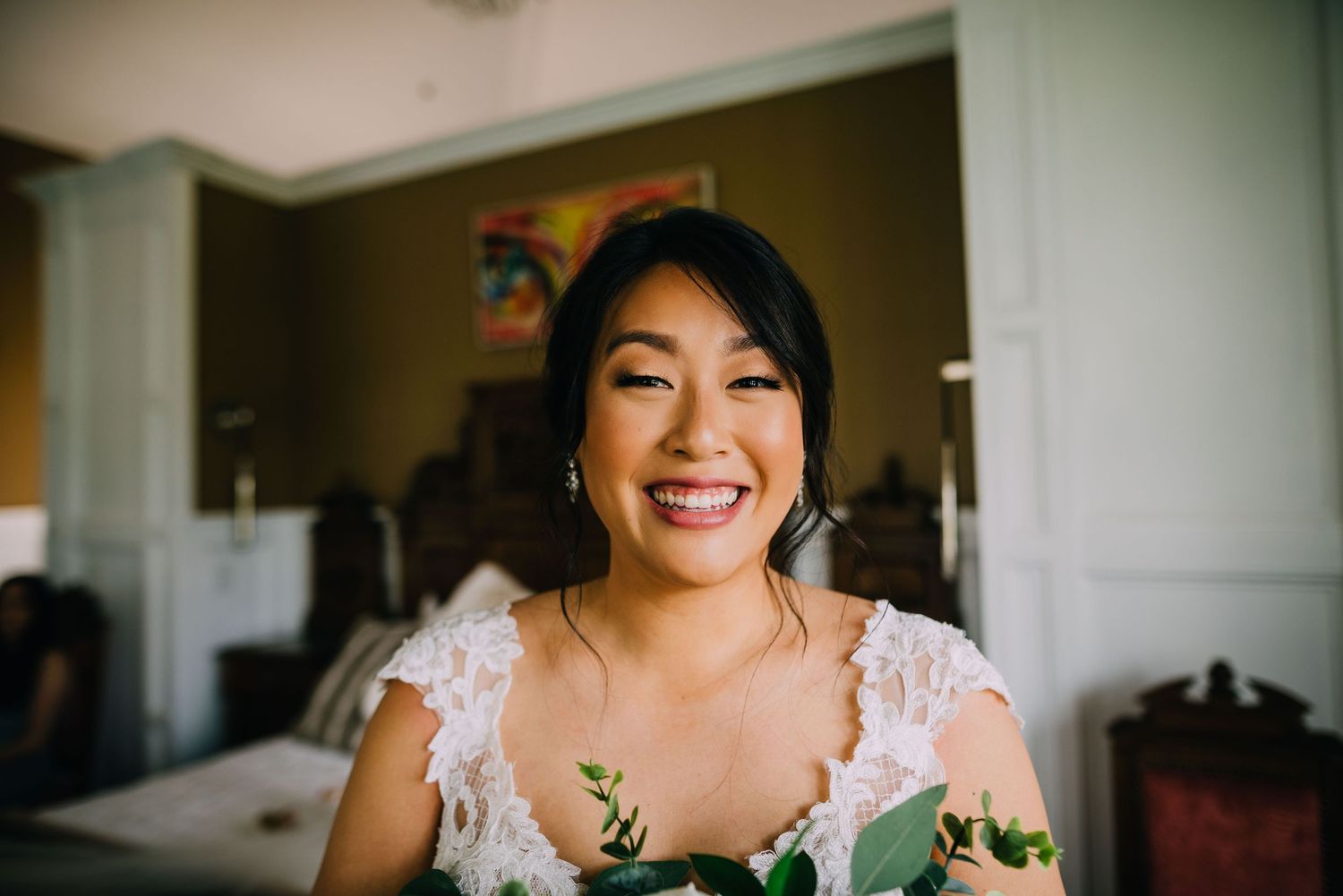 Jenn is ecstatic, she is about to get married and got her dress on. She stares right into the camera with a huge grin.