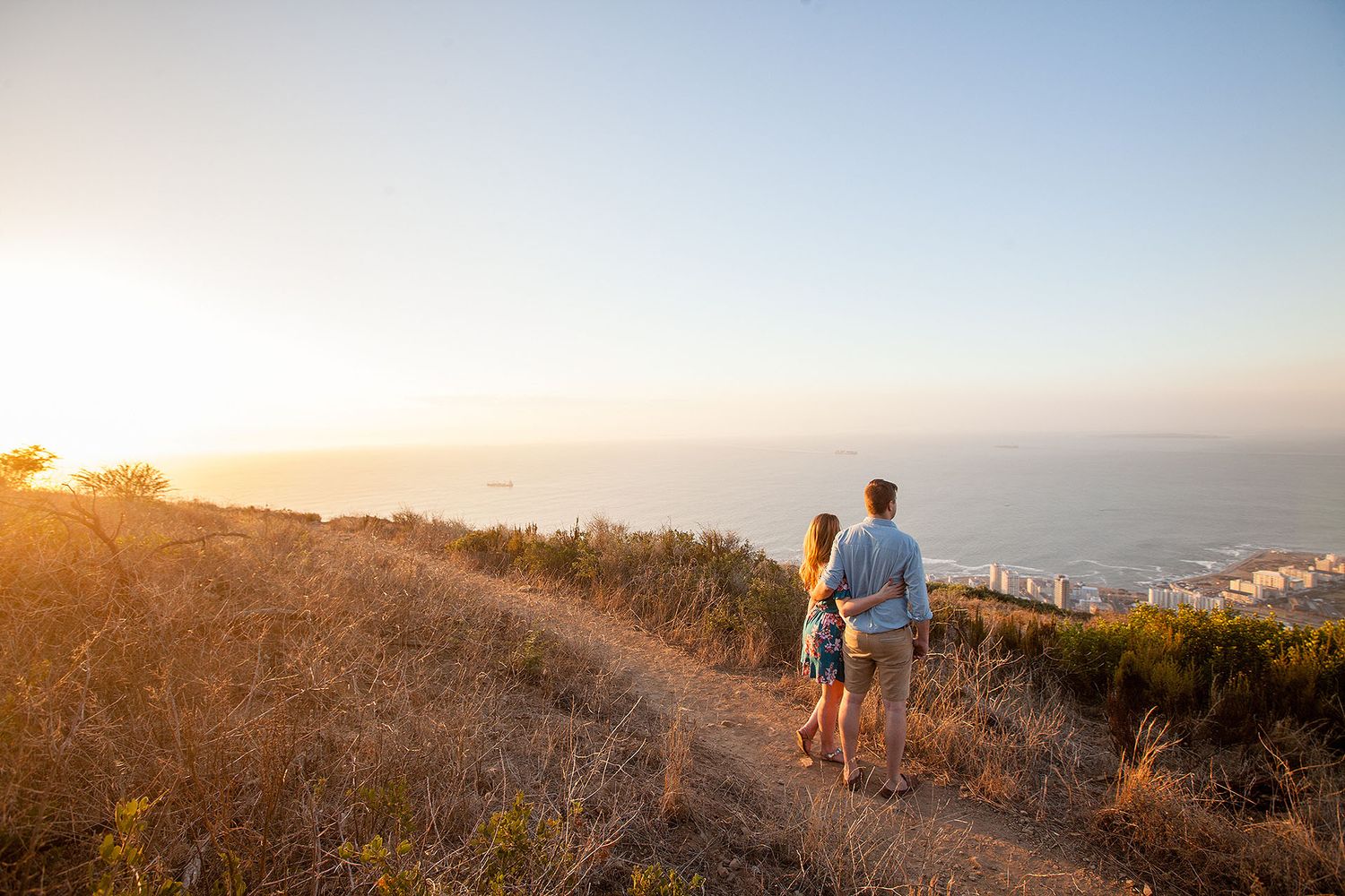 Affectionate couple holding hands during a sunset walk on the beach (Melbourne couples photography by Lesley Marks)