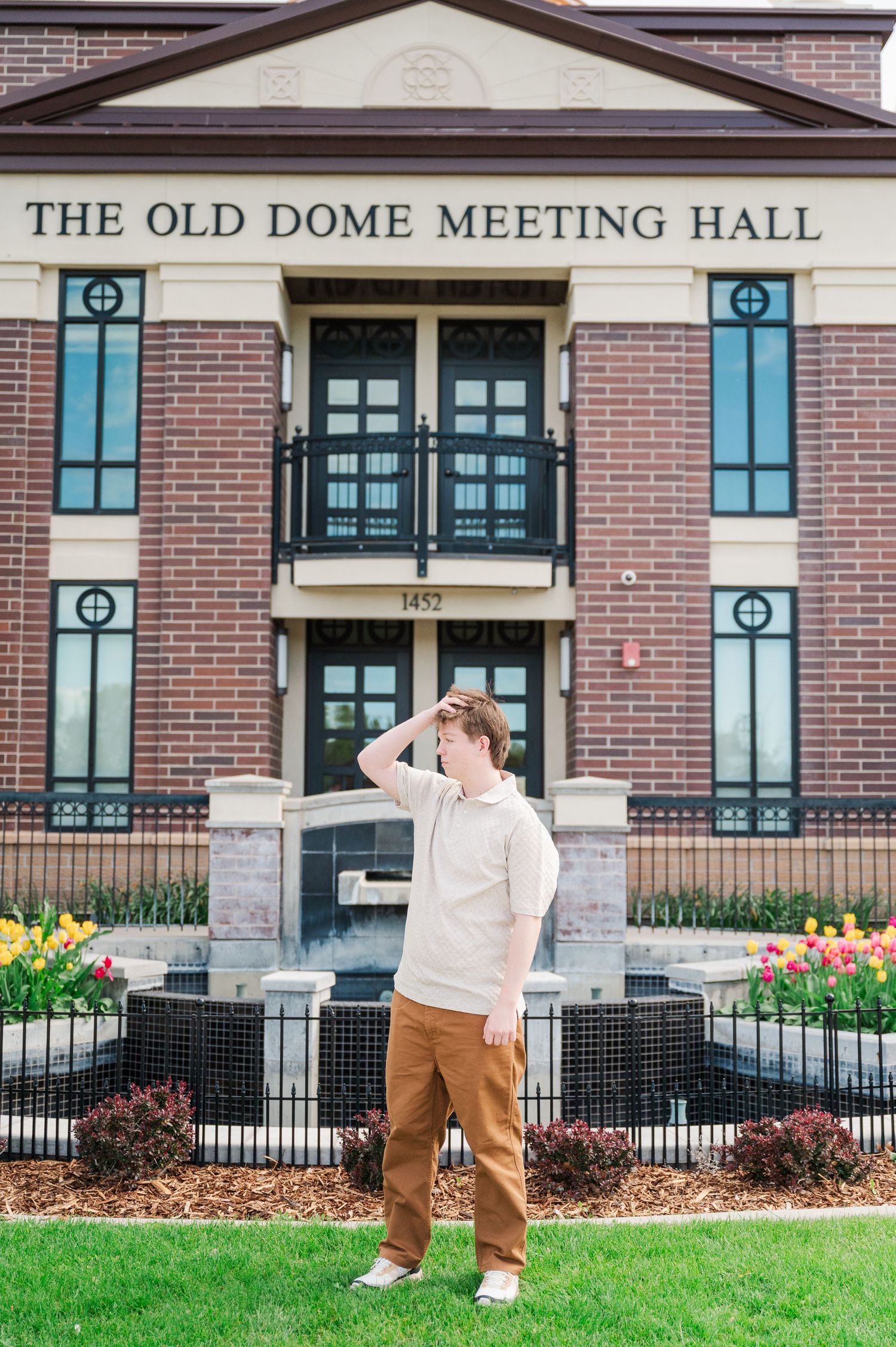 Historic Old Dome Meeting Hall building entrance with spring flowers in the foreground.