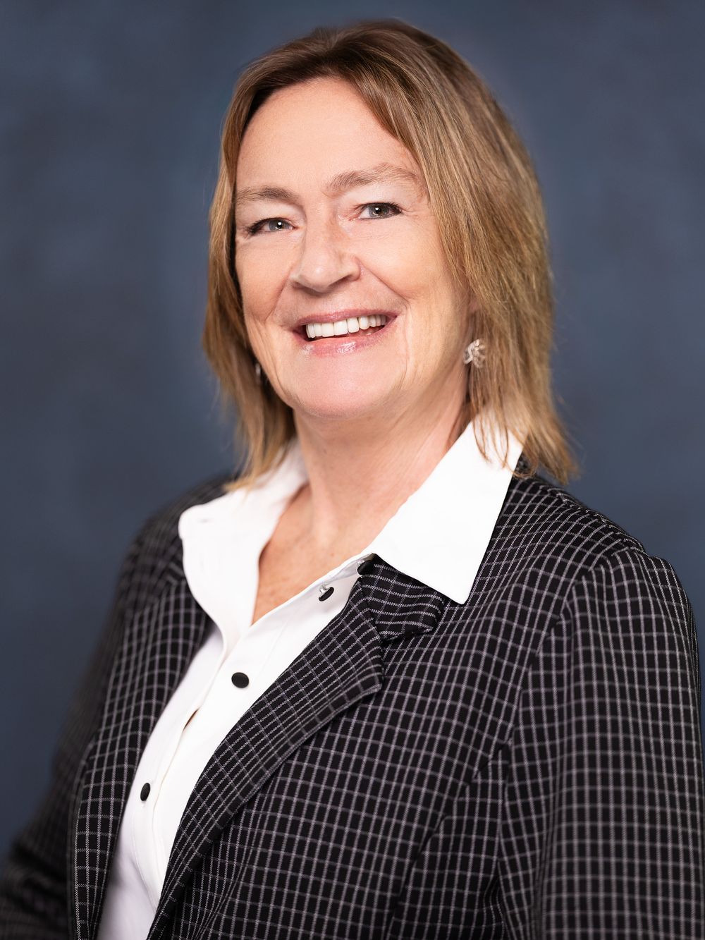 Corporate portrait sequence showing different angles of a person in checkered blazer and white blouse.