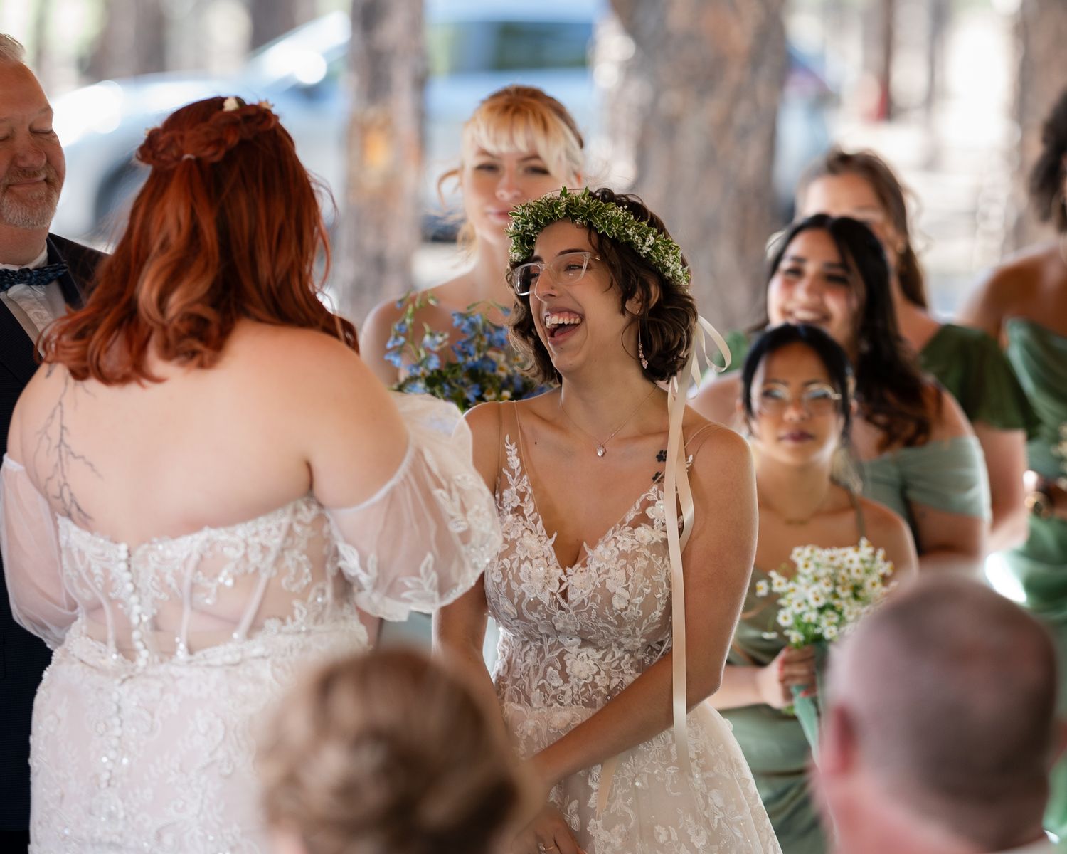 A joyous celebration during a wedding ceremony with guests and floral decorations.