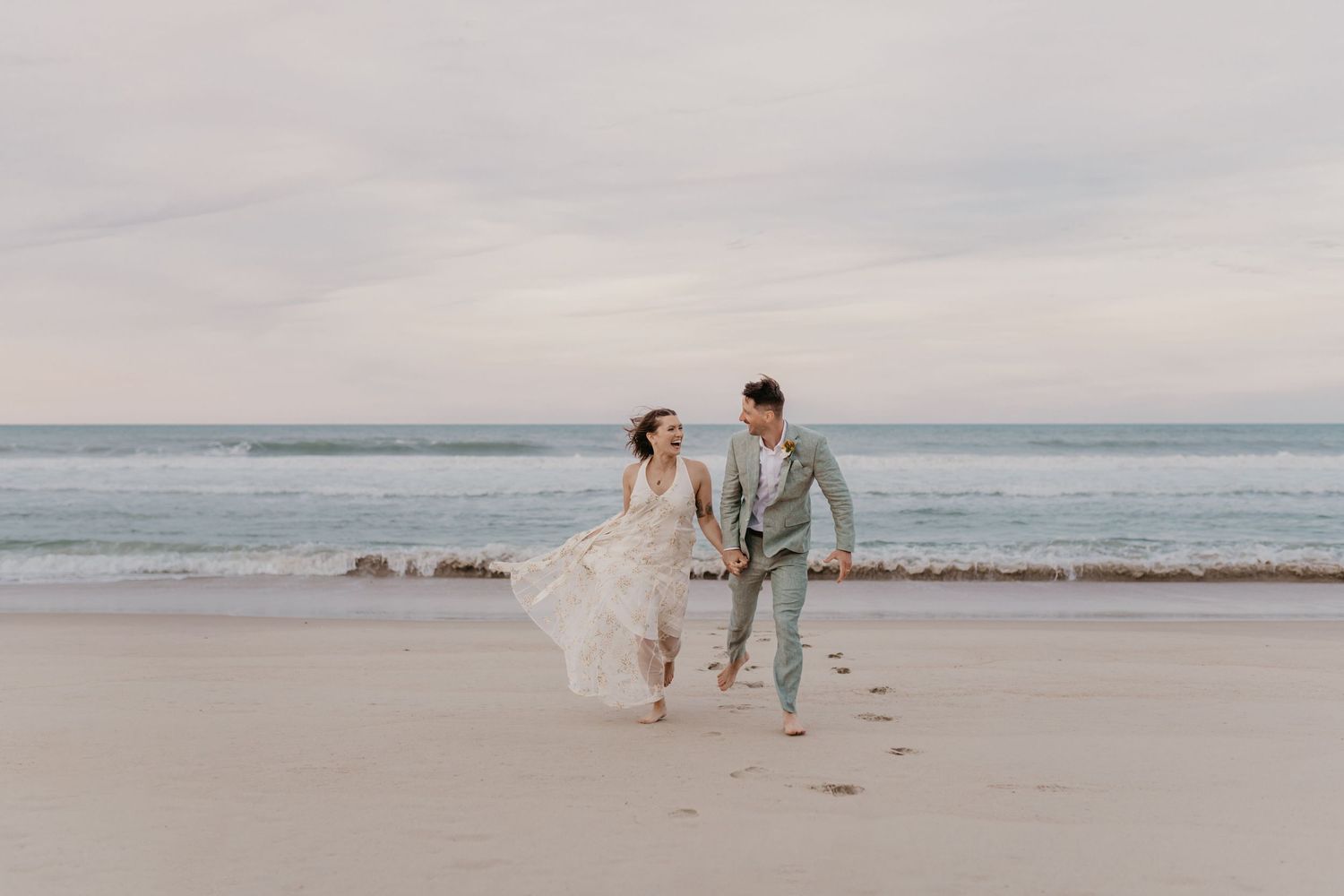 wedding couple posing on a beach in north carolina
