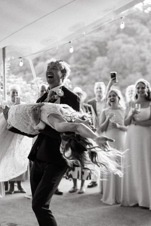 A sequence of four black and white photos showing a couple's romantic and energetic first dance at their wedding celebration.