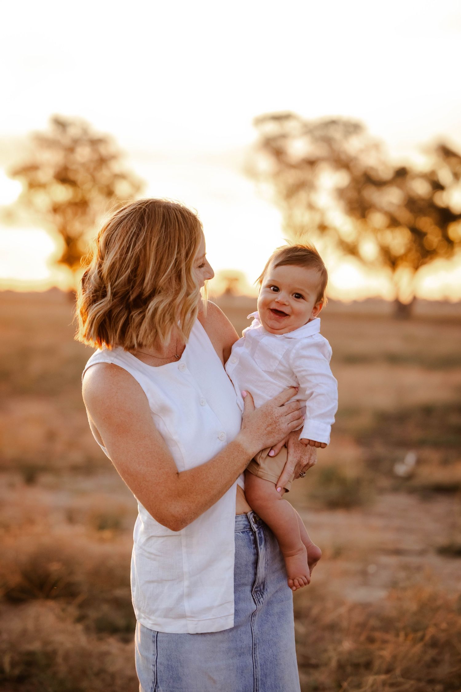 Golden hour outdoor family portraits with warm sunset backlighting.