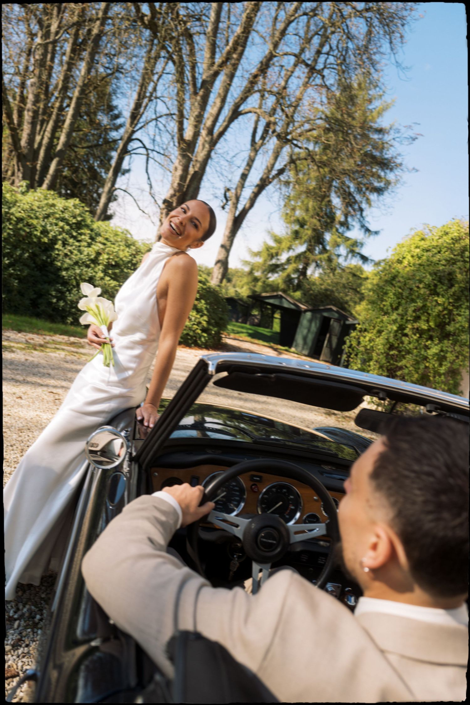 Interior view of people sitting in a car driving down a scenic road.